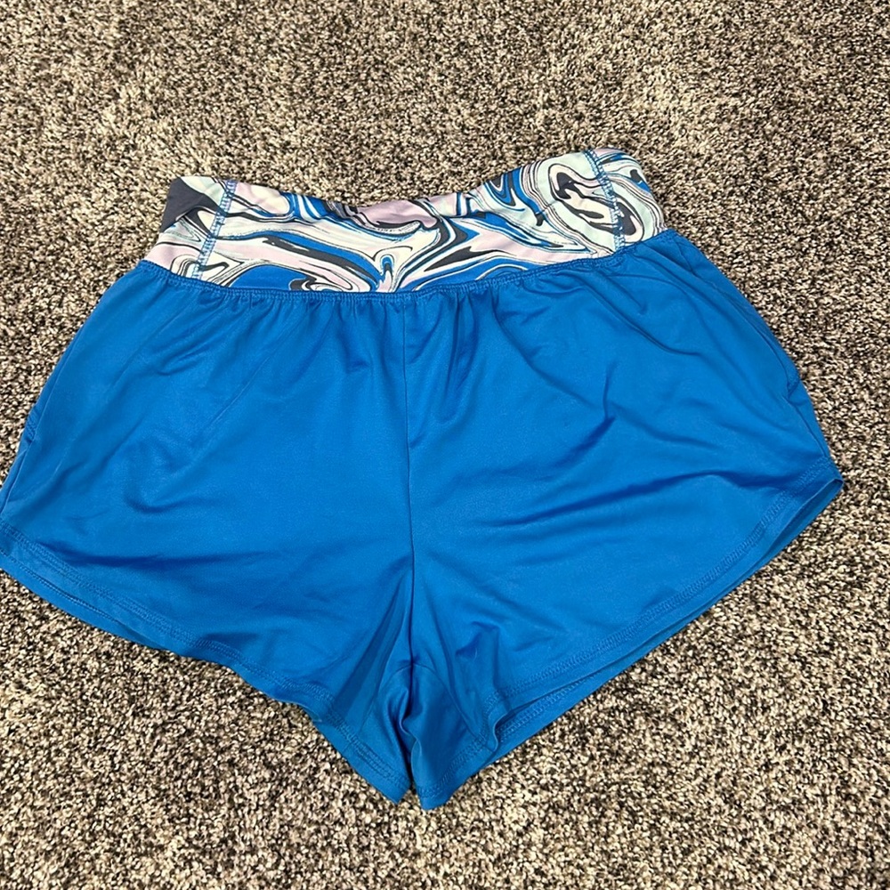 Blue athletic shorts with tight swirl waistband